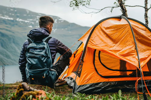 Pitching a tent in a remote wilderness, surrounded by towering peaks and alpine lakes, wanderlust.