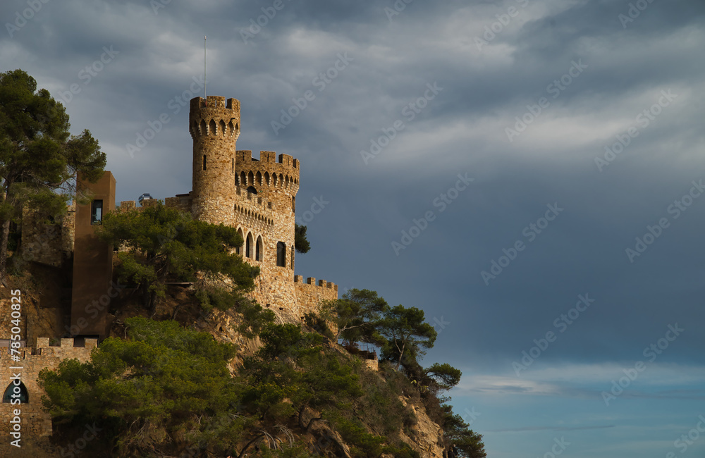 Image of the castle of Lloret de Mar dominating a cliff overlooking the Mediterranean, the Costa Brava With a typical Spanish castle Image of the castle of Lloret de Mar dominating a cliff overlooking the Mediterranean, the Costa Brava With a typical Spanish castle