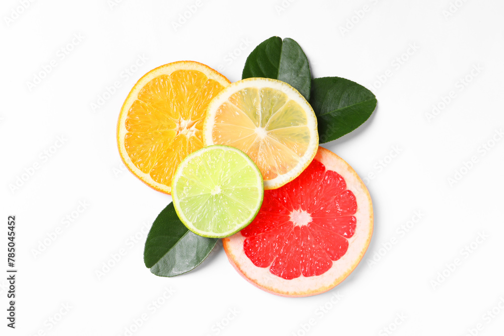 Slices of fresh ripe citrus fruits and green leaves on white background, flat lay Slices of fresh ripe citrus fruits and green leaves on white background, flat lay