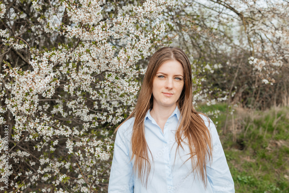 Woman standing near blossoming cherry tree Woman standing near blossoming cherry tree