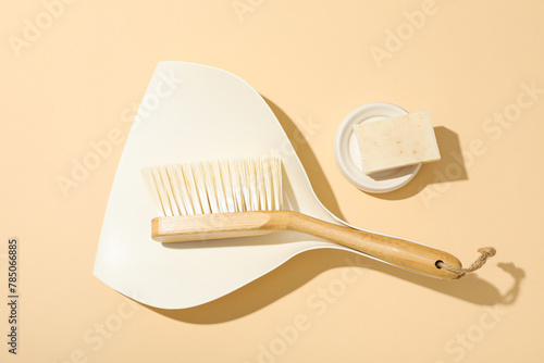 Soap and brush with scoop on beige background, top view © Atlas