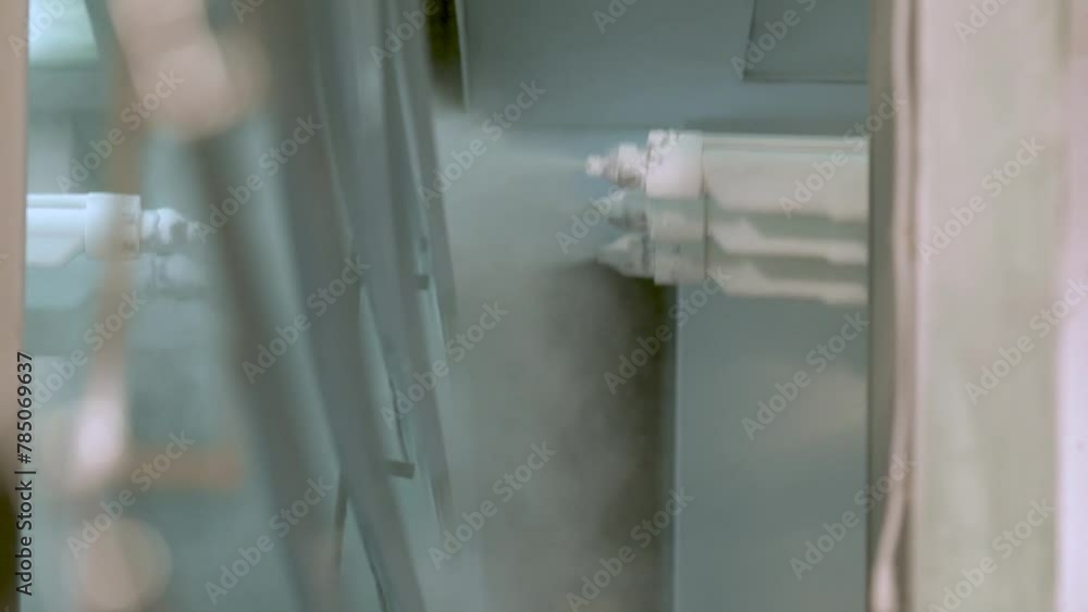Aluminum paint sprayer on metal work.Painting of aluminium profiles on factory Aluminum paint sprayer on metal work.Painting of aluminium profiles on factory