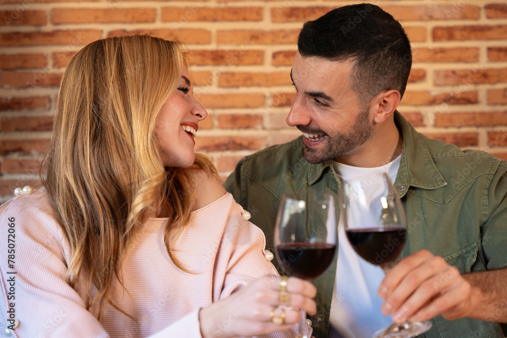 Young Caucasian couple smiling confident toasting with wine indoors. Young Caucasian couple smiling confident toasting with wine indoors.