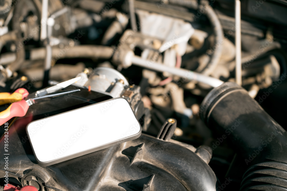 Fototapeta premium Mobile App Diagnoses Car Trouble. Engine Bay Inspection