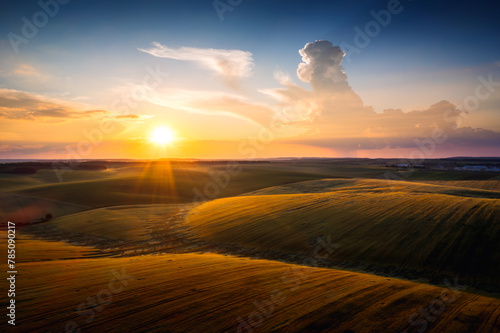Scenic view of fields and agricultural areas at sunset.