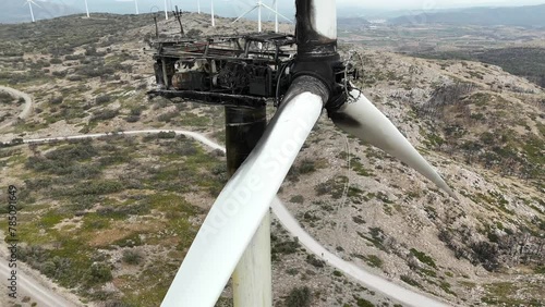 Extreme aerial  spinning shot of an air turbine destroyed by a fire in a rural arid area in SE Spain. 4K photo