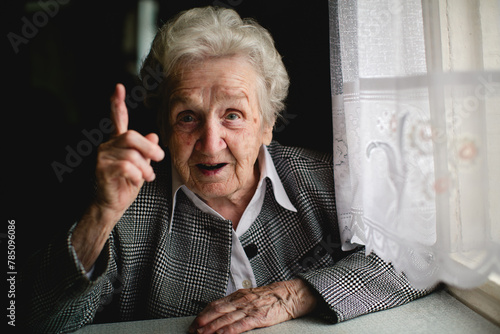Photograph of a mature lady with a significantly raised index finger.