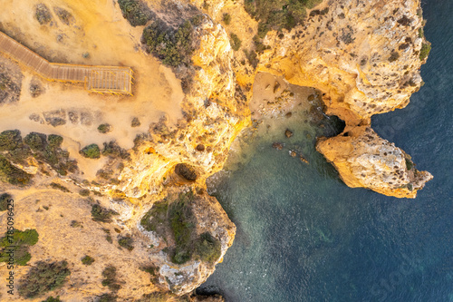 Sunrise over Ponta de Piedade  Algarve cliffs on coastline. Aerial drone view