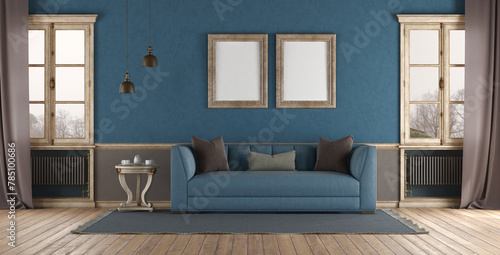 Elegant living room interior with blue sofa and blank frames