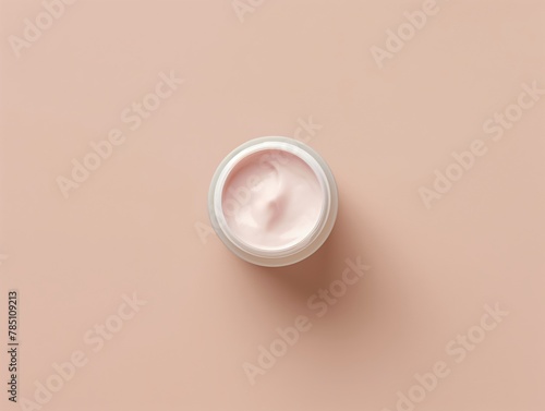 Top View of Face Cream on Soft Peach Colored Background - Isolated