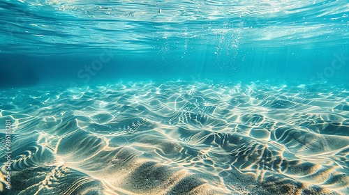 Sand ripples, underwater view, close-up, high-angle, ocean floor patterns, clear water 