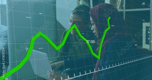 Image of graphs and changing numbers over diverse coworkers discussing reports on laptop