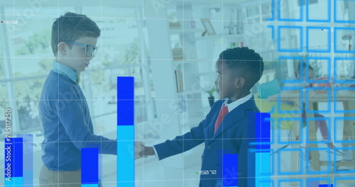 Image of graphs, changing numbers and map over schoolboys shaking hands in classroom
