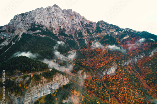 Aerial view of treecovered mountain with clouds hovering above photo