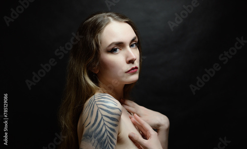 Portrait of beautiful sensual woman with tattoos, close-up. Studio shot. © Vladimir Arndt