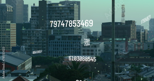 Image of numbers processing over cityscape