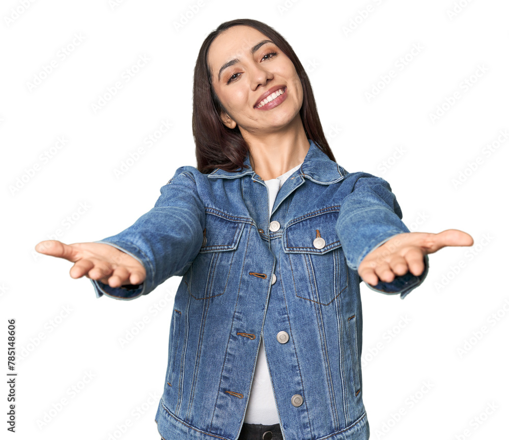 Modern young Caucasian woman portrait on studio background showing a welcome expression. Modern young Caucasian woman portrait on studio background showing a welcome expression.