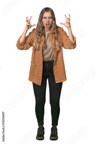 Studio portrait of a blonde Caucasian woman screaming with rage.