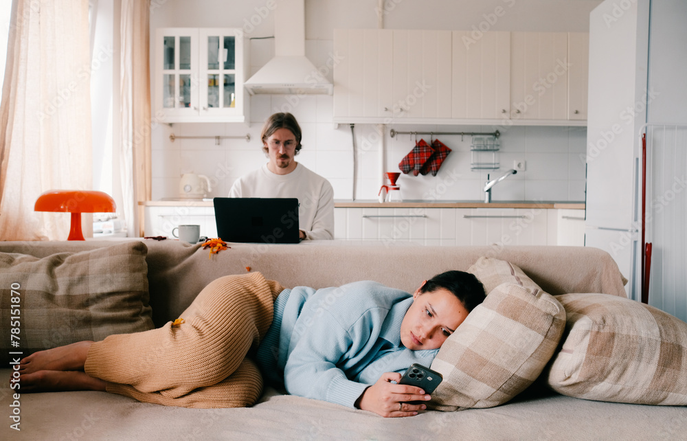 Young couple family working at home with laptop and smartphone. Young couple family working at home with laptop and smartphone.