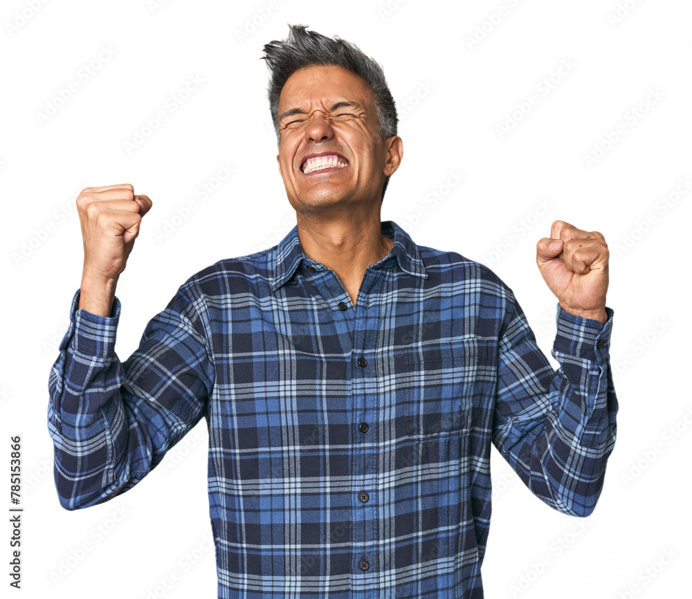 Middle-aged Latino man raising fist after a victory, winner concept. Middle-aged Latino man raising fist after a victory, winner concept.