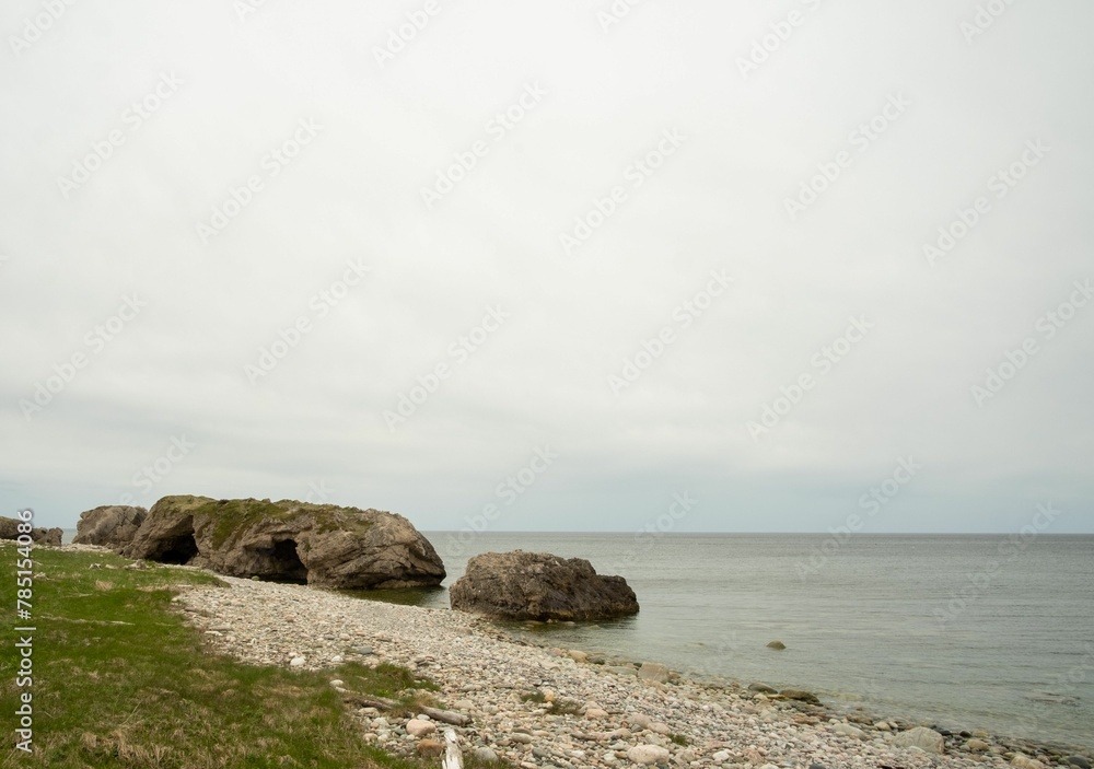 Beautiful seascape view with some rocks and the ocean against a cloudy sky