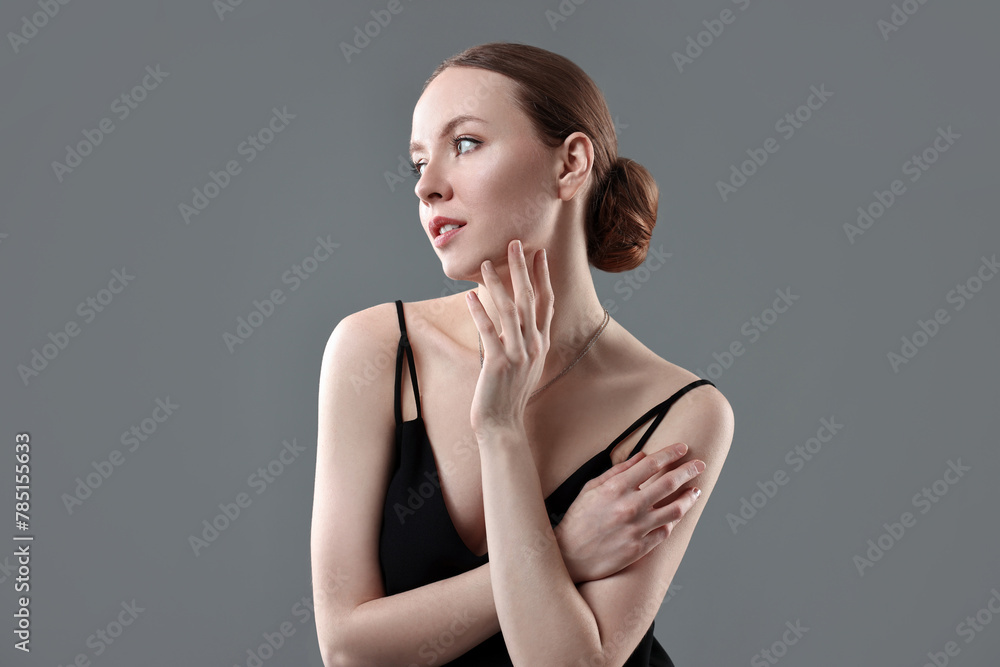 Fototapeta premium Fashionable portrait of beautiful young woman on grey background