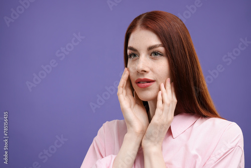 Portrait of beautiful woman on purple background. Space for text
