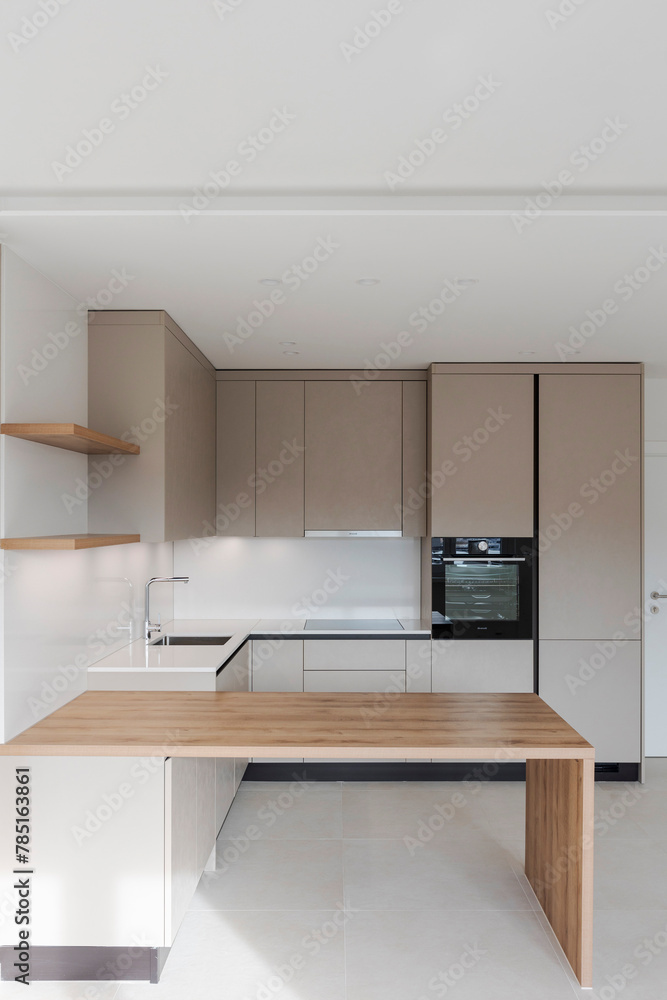 Fototapeta premium Interior of a modern kitchen with a wooden table or worktop. Everything is new and there are no objects around