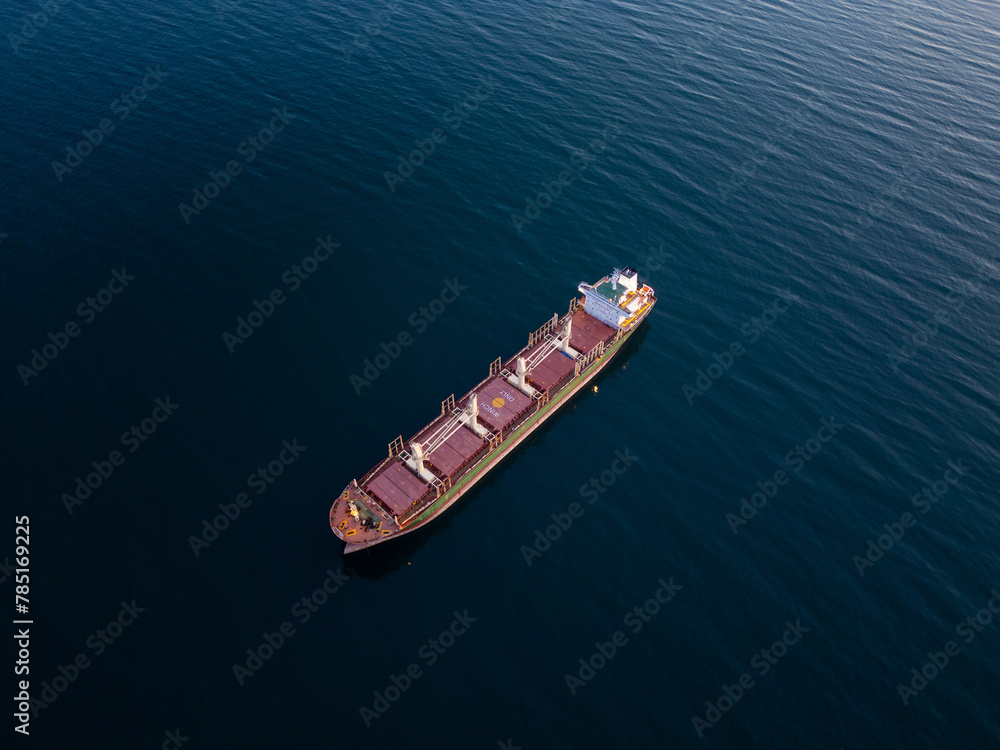 Large bulk carrier cargo ship Floating on Vast Water Large bulk carrier cargo ship Floating on Vast Water