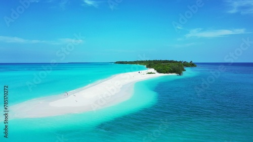 Aerial shot of a white sandy beach with tropical trees in an island with turquoise water