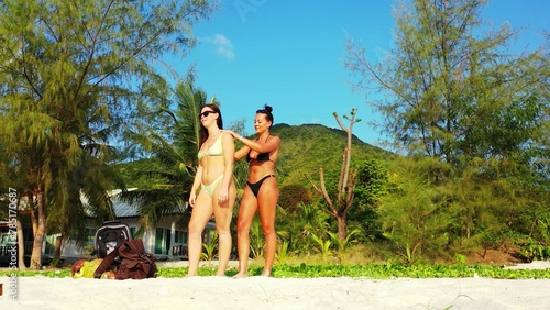 Beautiful shot of two females relaxing at the beach in Koh Samui  Thailand