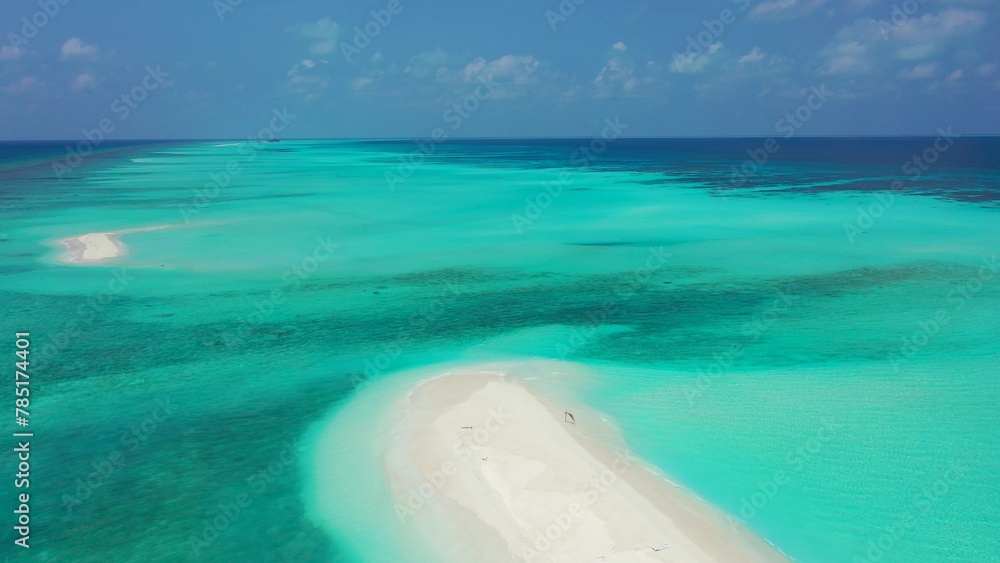 Aerial view of a white sand beach in a turquoise water