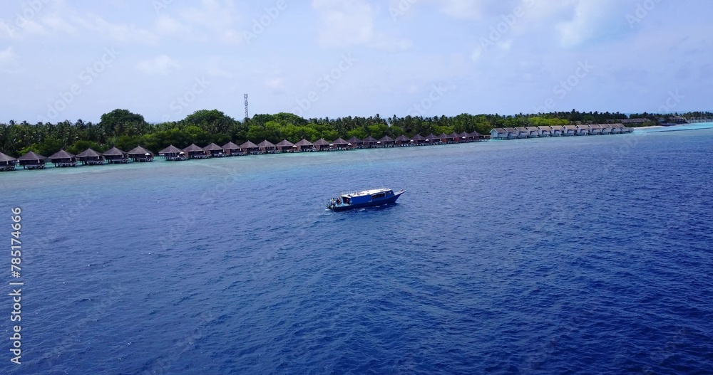 Fototapeta premium Aerial shot of a ship on a blue calm water