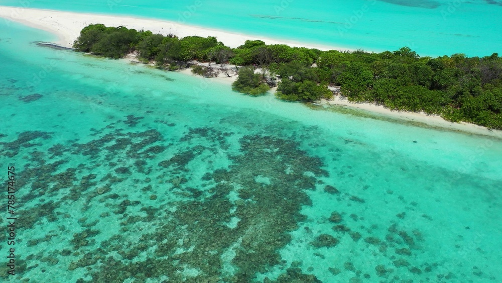 Aerial view of a small tropical island with a white sandy beach and turquoise water Aerial view of a small tropical island with a white sandy beach and turquoise water