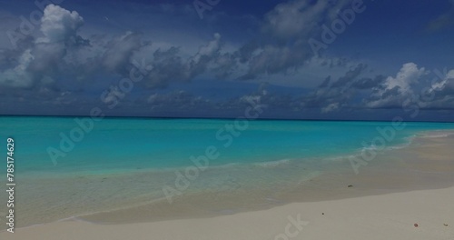 White sandy beach with turquoise water under a blue sky
