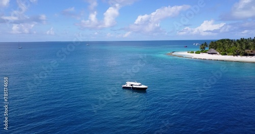 Fototapeta Naklejka Na Ścianę i Meble -  Aerial shot of a ship on a blue calm water