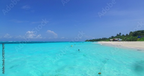 Beautiful Turquoise sea water and a small island in the distance © Wirestock