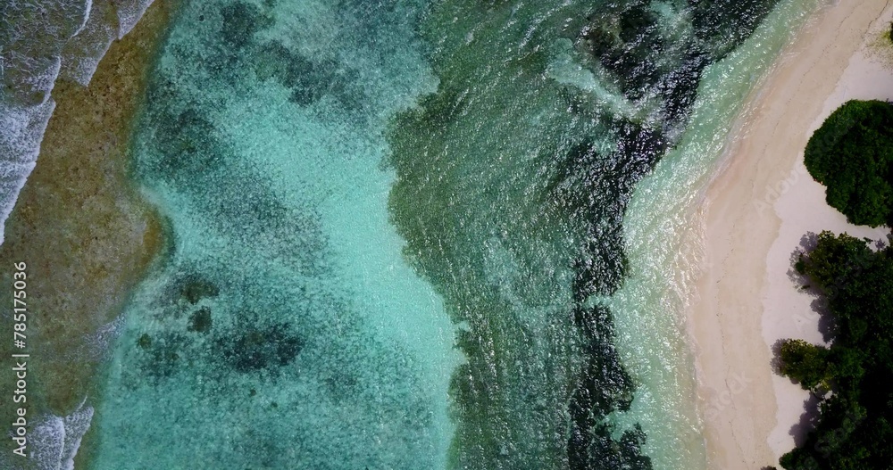 Aerial shot of ocean waves covering the coastline