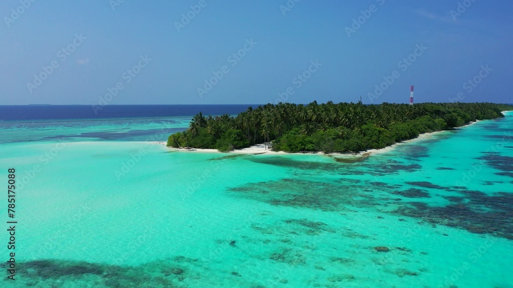 Aerial shot of a tropical island in the azure ocean Aerial shot of a tropical island in the azure ocean