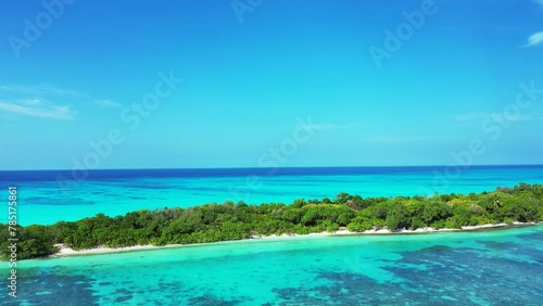 Fototapeta Naklejka Na Ścianę i Meble -  Aerial view of the azure water of the ocean and a green island in Asia