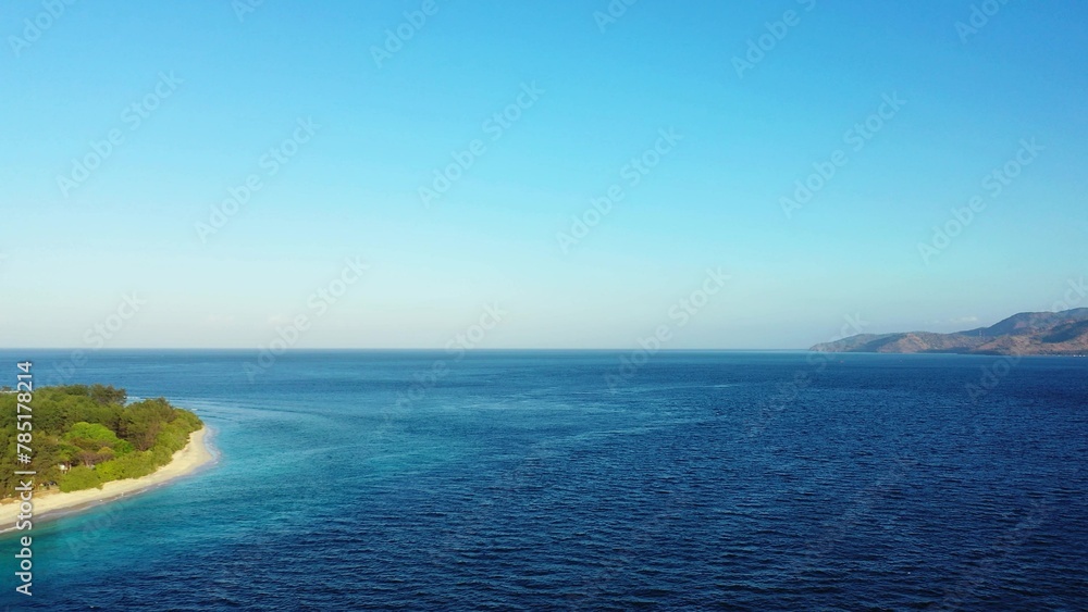 Beautiful view of a sea with an island on a sunny day Beautiful view of a sea with an island on a sunny day