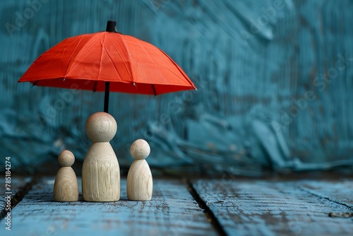 Family protection concept, wooden figures under red umbrella, serene blue, space for copy photo