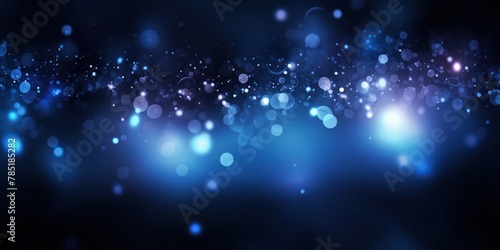 Indigo abstract glowing bokeh lights on a black background with space for text or product display. 