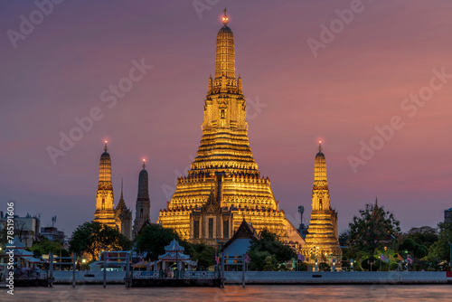 Wat Arun stupa  a significant landmark of Bangkok  Thailand  stands prominently along the Chao Phraya River  with a beautiful twilight.