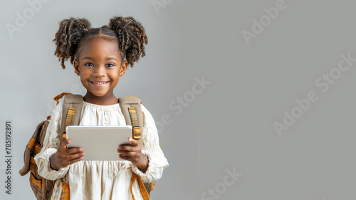 African school girl holding tablet with backpack, student, technology, education photo