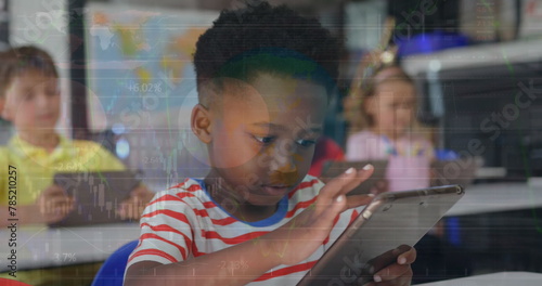 Image of african american cute boy using digital tablet in classroom over infographic interface