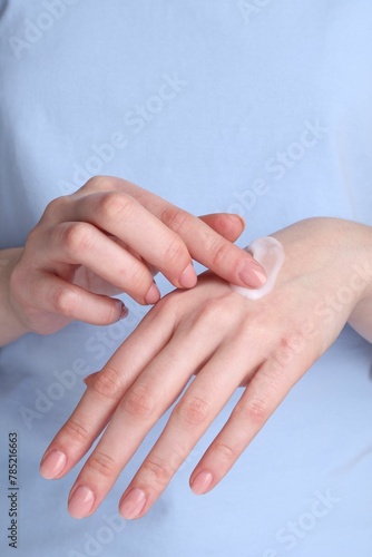 Woman applying cream on her hands  closeup