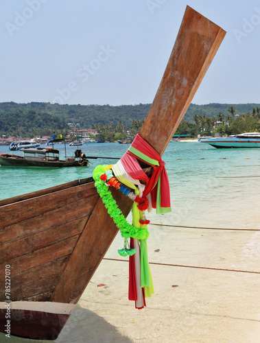 Boat Longtail decorated with silk tapes expects tourists