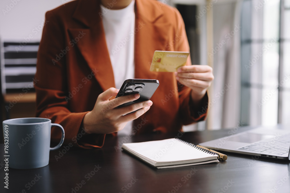 businesswoman hand using smart phone, tablet payments and holding credit card online shopping, omni channel, digital tablet businesswoman hand using smart phone, tablet payments and holding credit card online shopping, omni channel, digital tablet
