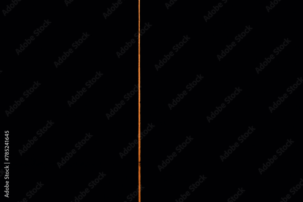 Light creeps through a door slot in a dark room at home Light creeps through a door slot in a dark room at home